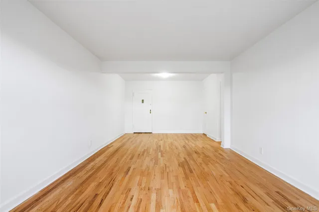 a living room with furniture a flat screen tv and a window