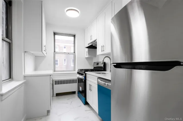 a kitchen with stainless steel appliances granite countertop a sink a stove and a refrigerator