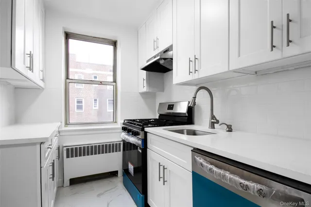 a kitchen with stainless steel appliances a sink stove and cabinets
