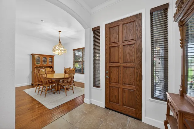 a living room with furniture a flat screen tv and a floor to ceiling window