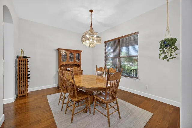 a view of a dining room with furniture wooden floor and chandelier