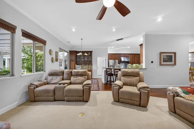 a living room with stainless steel appliances granite countertop furniture and a window