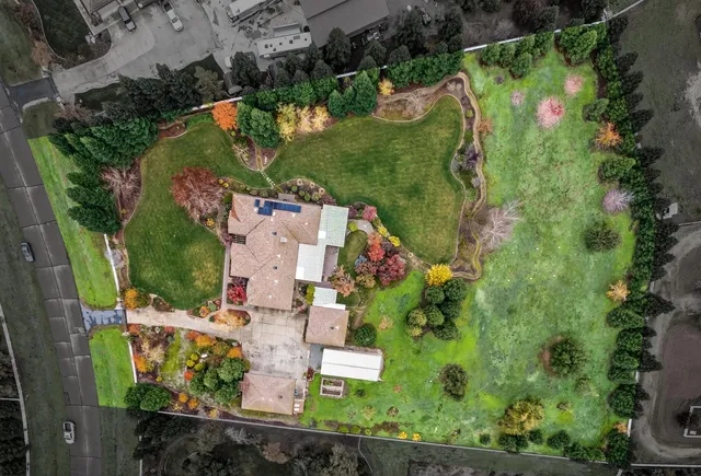 a view of a big yard with a house in the background