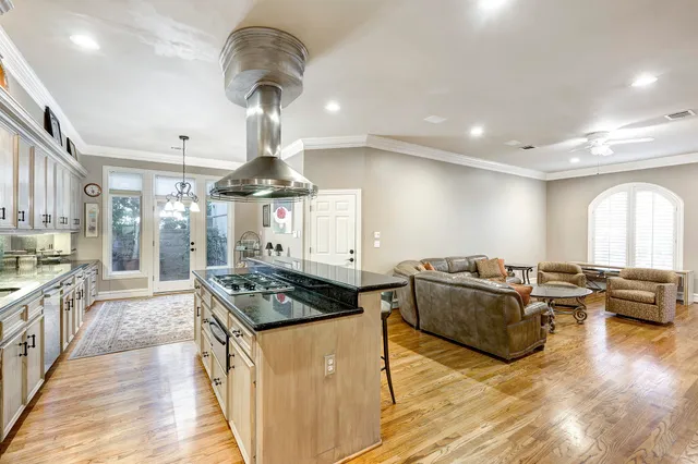 a kitchen with stove and a chandelier