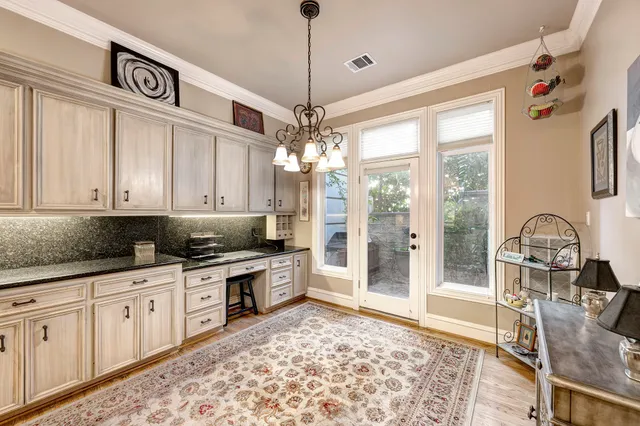 a kitchen with stainless steel appliances granite countertop a stove a sink and a refrigerator with wooden floor