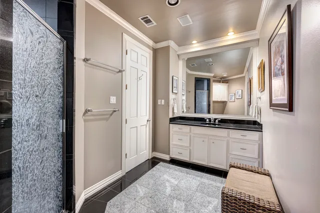 a spacious bathroom with a granite countertop sink and a mirror