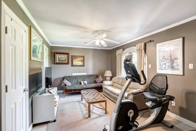 a living room with furniture a window and a flat screen tv
