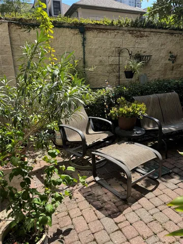 a view of a chairs and table in a backyard