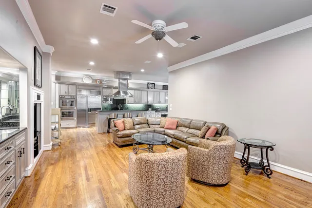 a living room with furniture and a chandelier