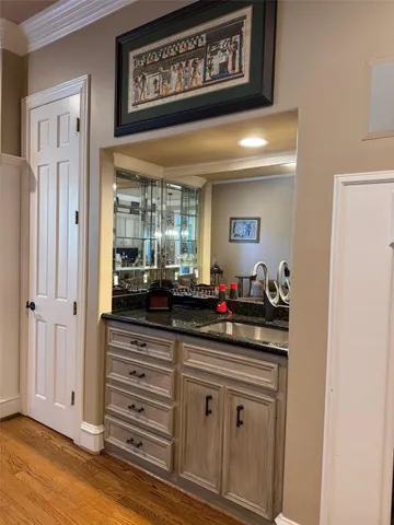 a view of a hallway with a mirror and dresser