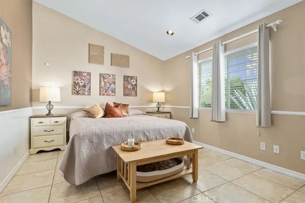 a bedroom with a bed couch and window