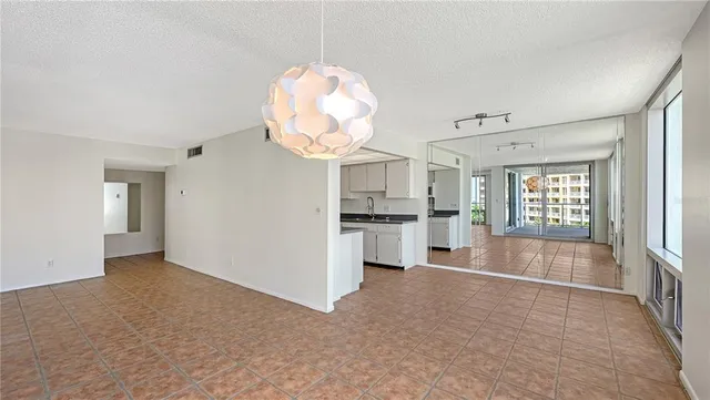 a view of kitchen with cabinets and window