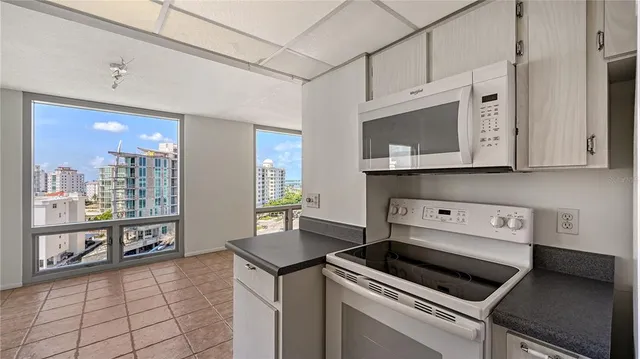 a kitchen with stainless steel appliances a stove microwave and cabinets