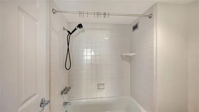 a bathroom with a shower and a shower