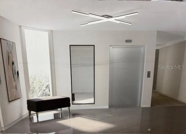 a view of a big room with a large window wooden floor and cabinet