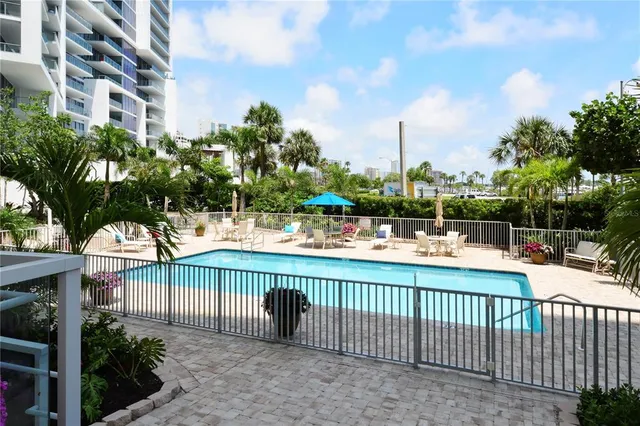 a view of swimming pool with outdoor seating and city view