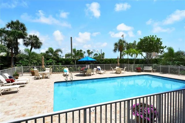 a view of a swimming pool with outdoor seating