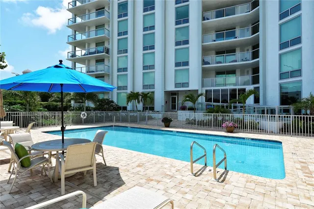 a view of a patio with table and chairs and potted plants with palm trees