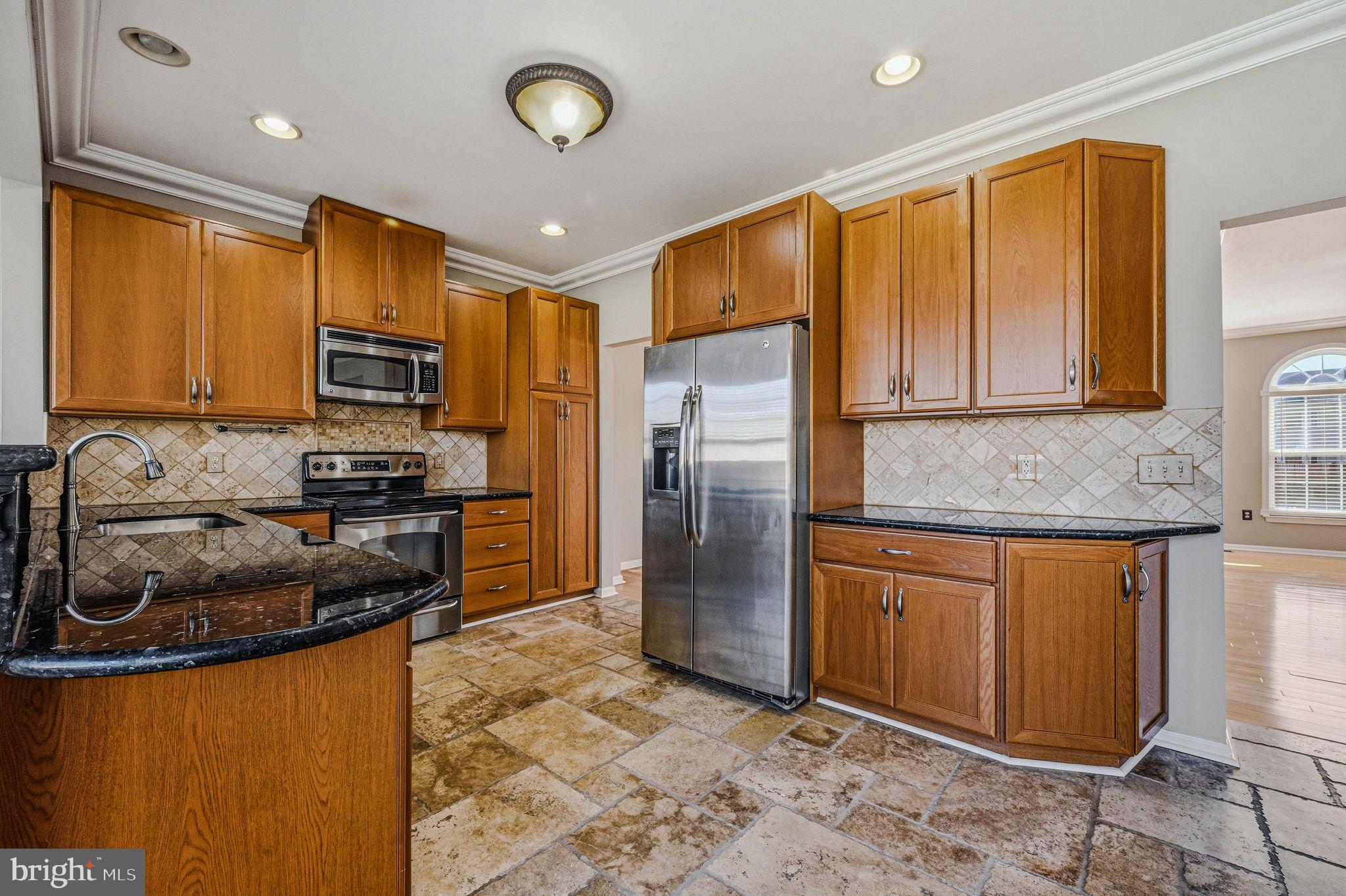 13 Laurel Way Bear, DE 19701 - Photo 19 of 44 a kitchen with stainless steel appliances granite countertop a stove a sink dishwasher a refrigerator and a microwave