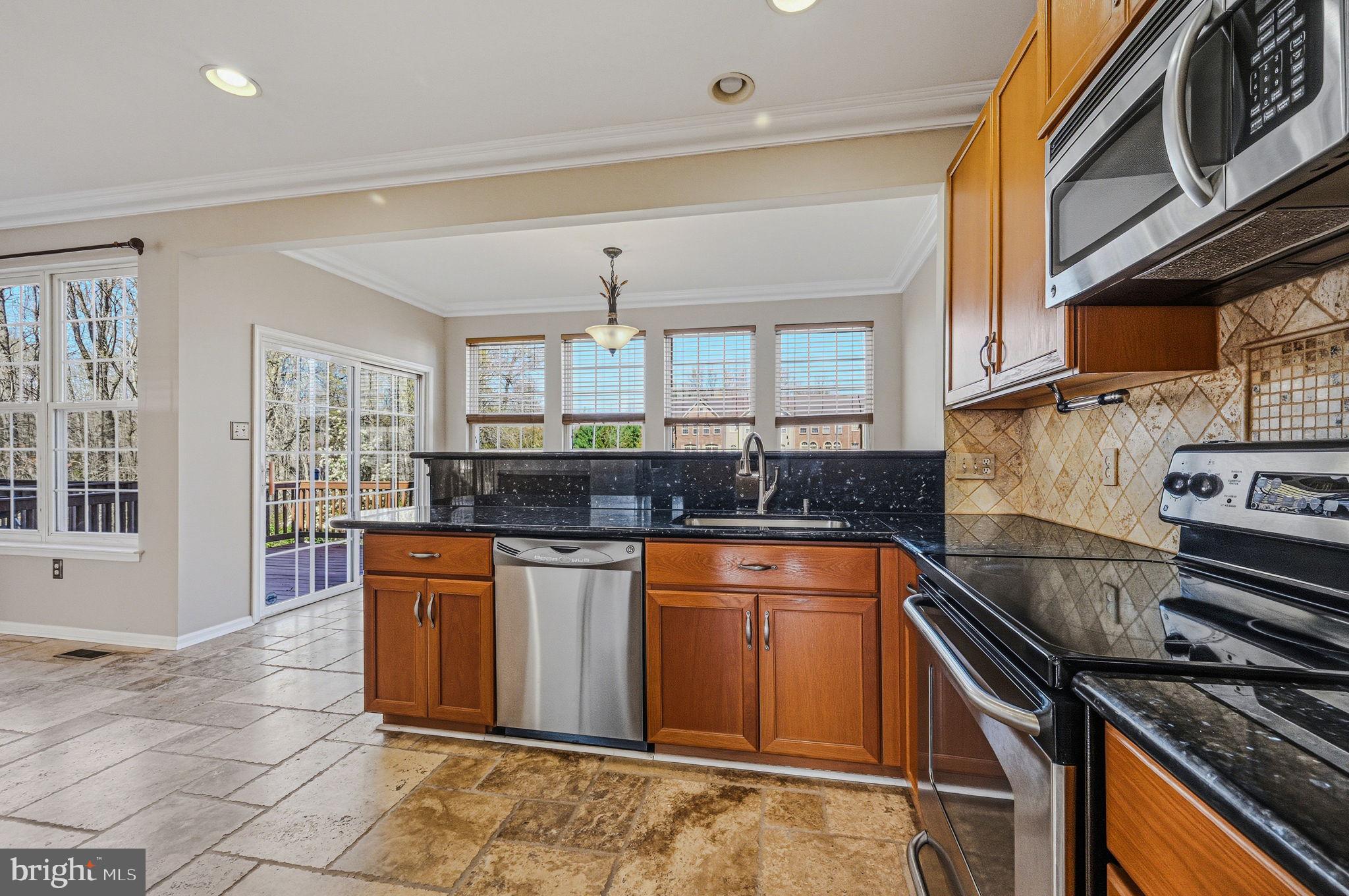 13 Laurel Way Bear, DE 19701 - Photo 20 of 44 a kitchen with stainless steel appliances granite countertop a stove a sink and a microwave