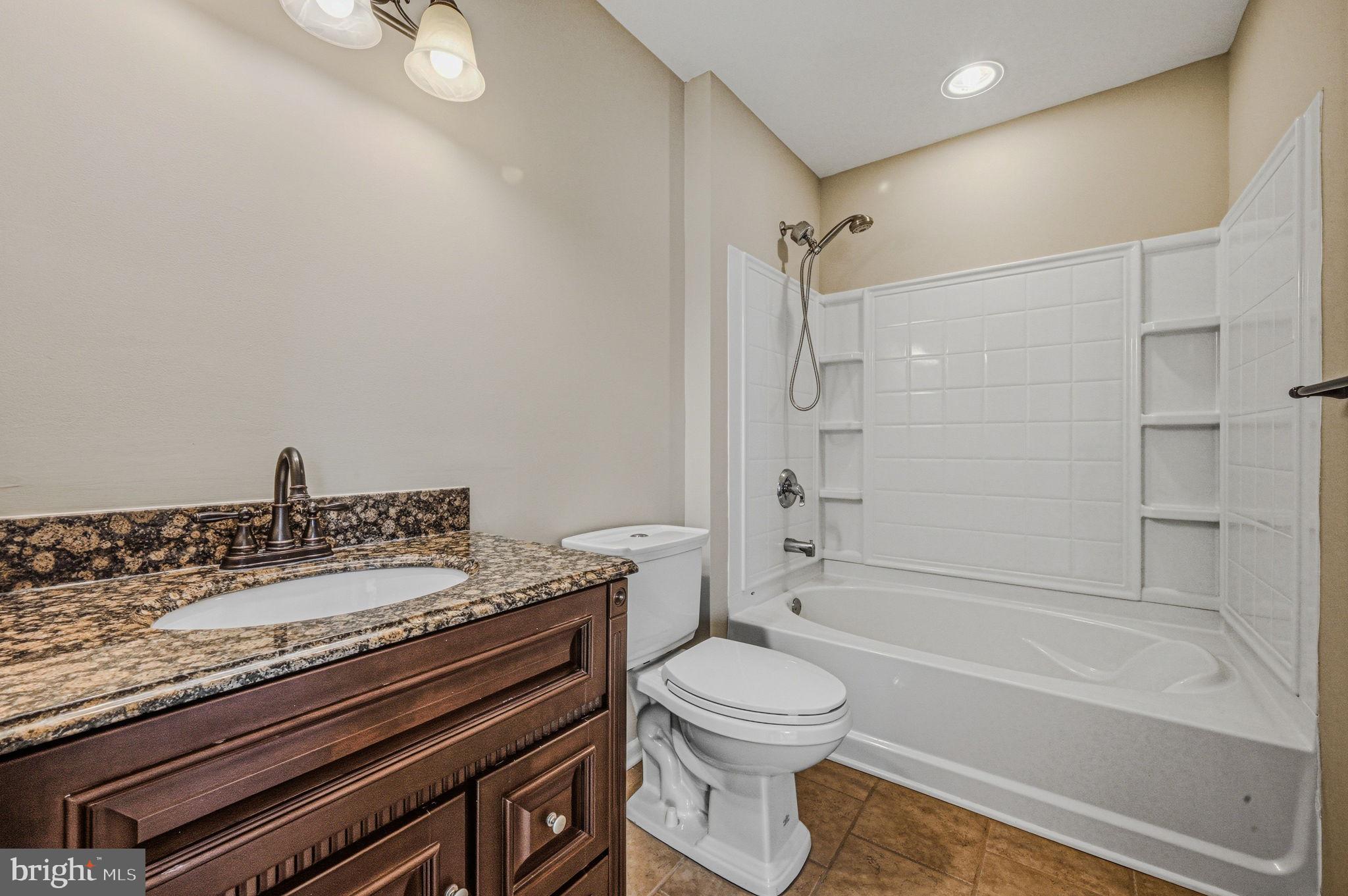 13 Laurel Way Bear, DE 19701 - Photo 36 of 44 a bathroom with a granite countertop bathtub shower sink vanity and toilet