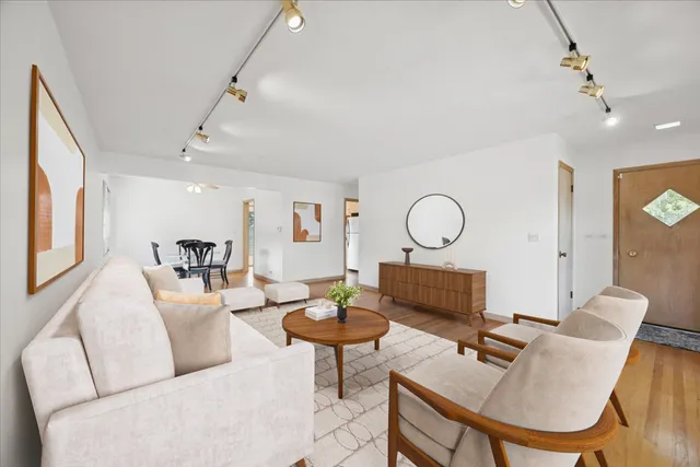 a living room with furniture and a floor to ceiling window