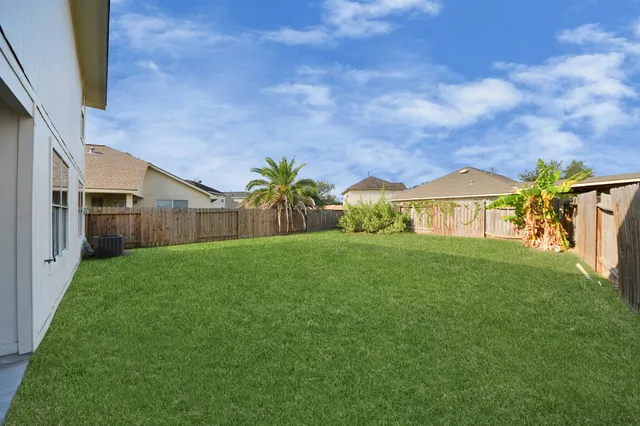 a view of an house with backyard space and garden