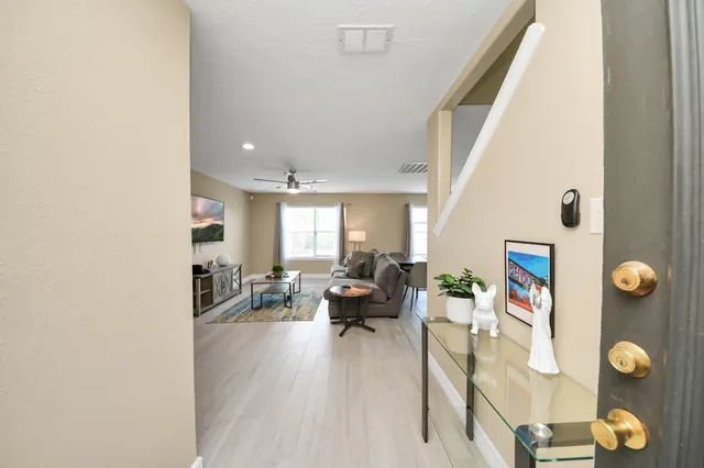 a living room with furniture and floor to ceiling window