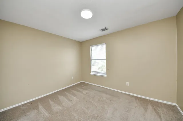 an empty room with a empty space and windows