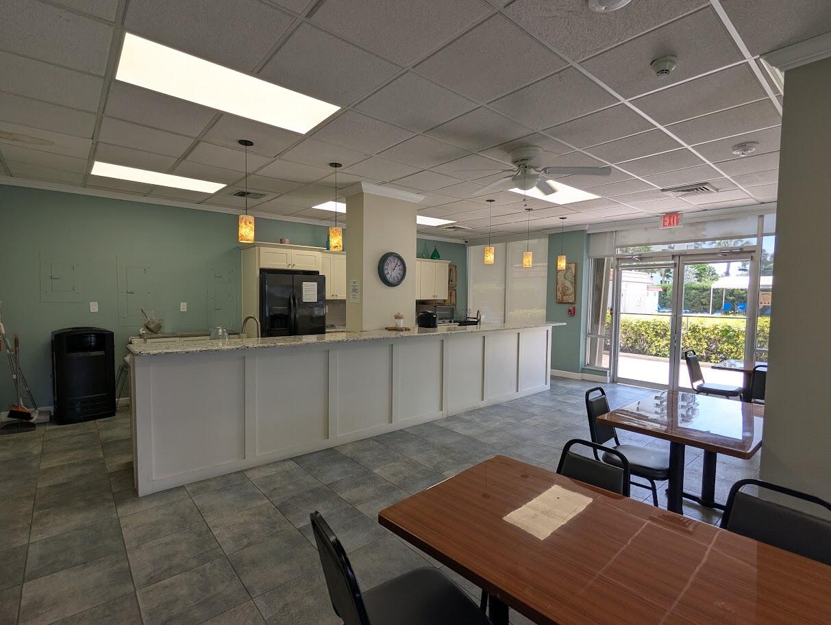 2121 North Ocean Boulevard, Unit 1006E Boca Raton, FL 33431 - Photo 57 of 64 a living room with furniture a rug kitchen view and a faucet