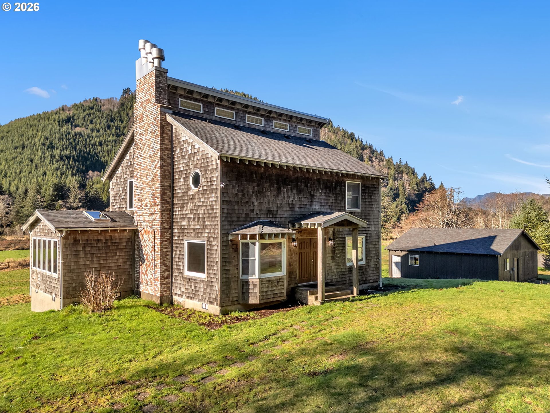 a front view of a house with a garden