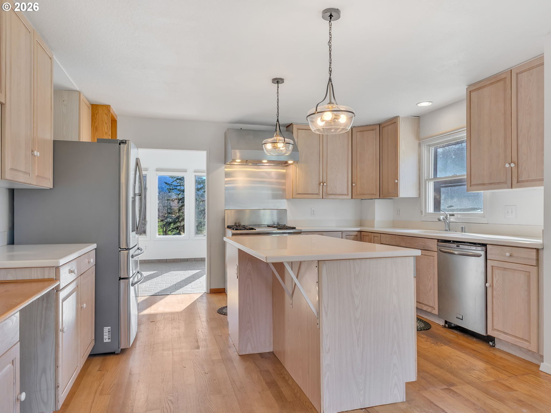 32300 Miami Foley Road Nehalem, OR 97131 - Photo 18 of 45 a open kitchen with stainless steel appliances granite countertop a sink a stove a refrigerator and island with wooden floor