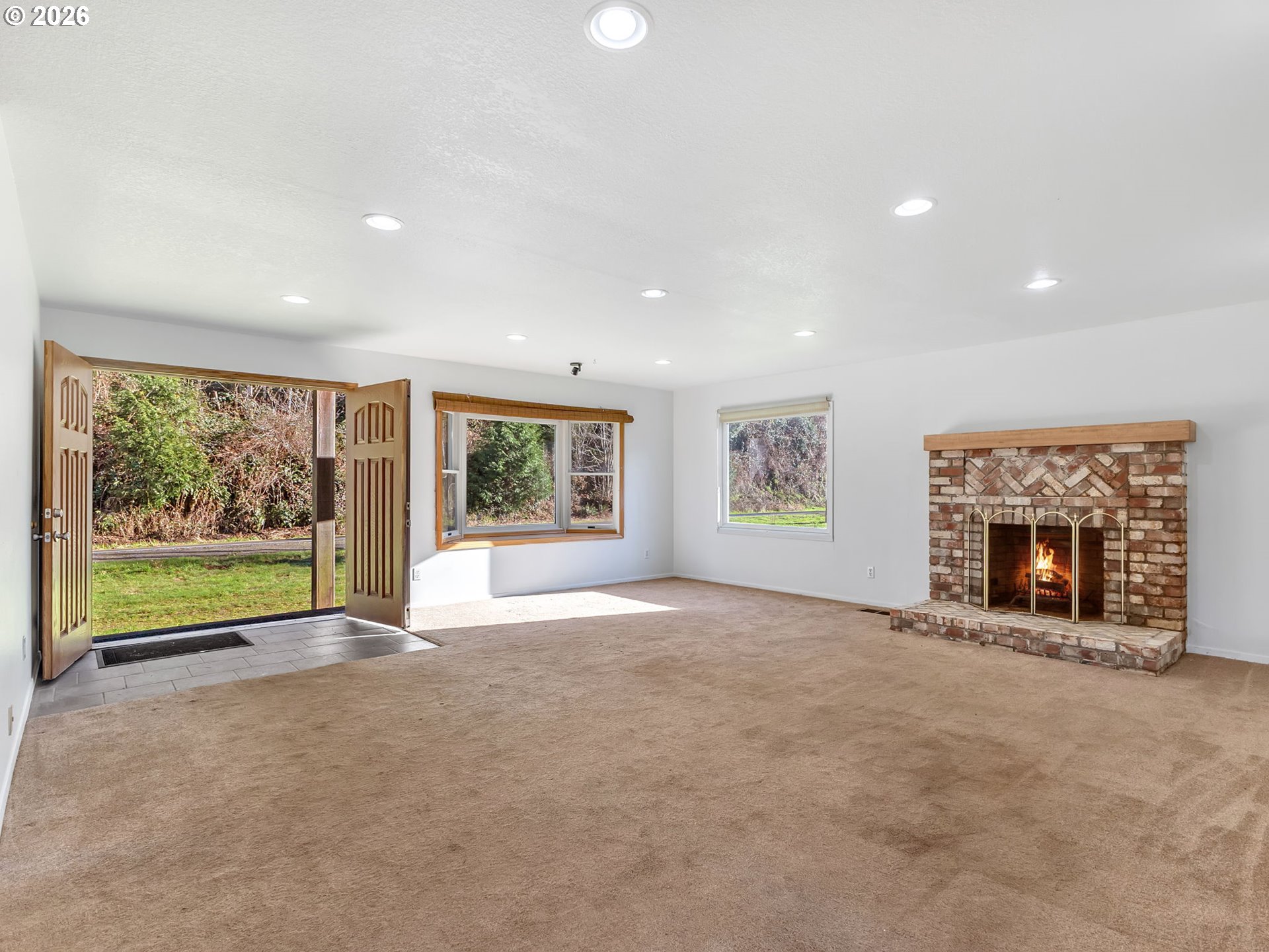 32300 Miami Foley Road Nehalem, OR 97131 - Photo 8 of 45 a view of an empty room with a window and a fireplace
