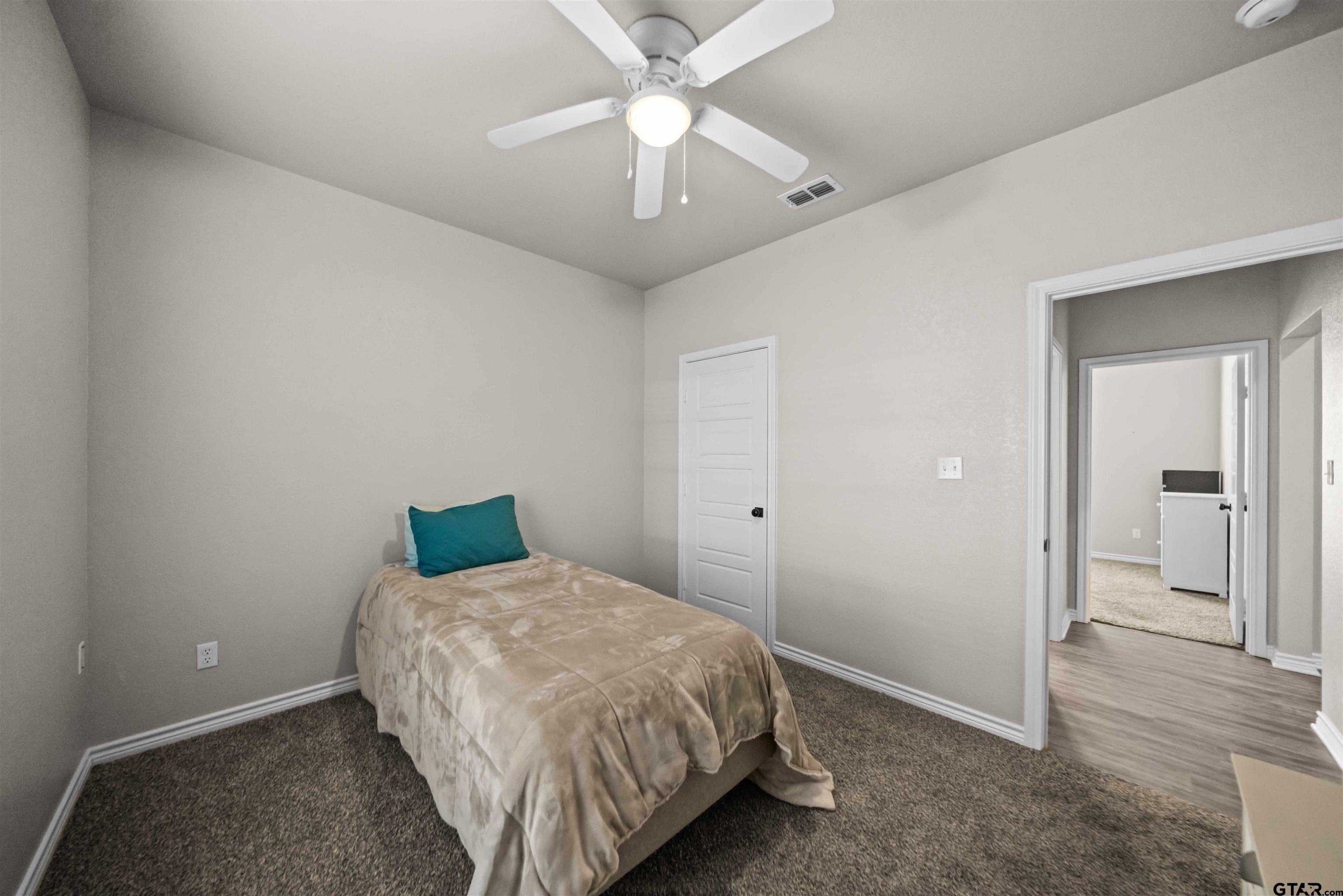 17023 County Road 2282 Troup, TX 75789 - Photo 25 of 30 a bedroom with a bed and a chandelier