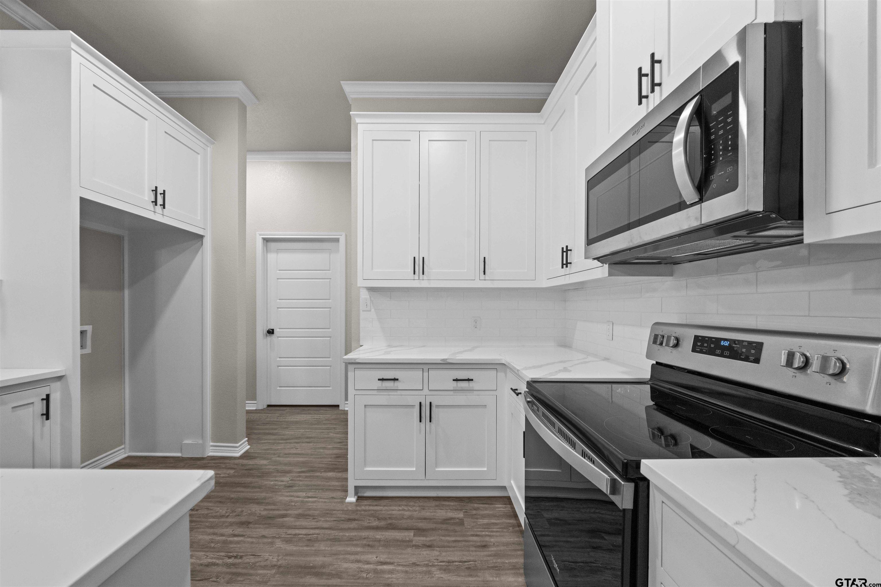 17023 County Road 2282 Troup, TX 75789 - Photo 8 of 30 a kitchen with stainless steel appliances a stove microwave and cabinets