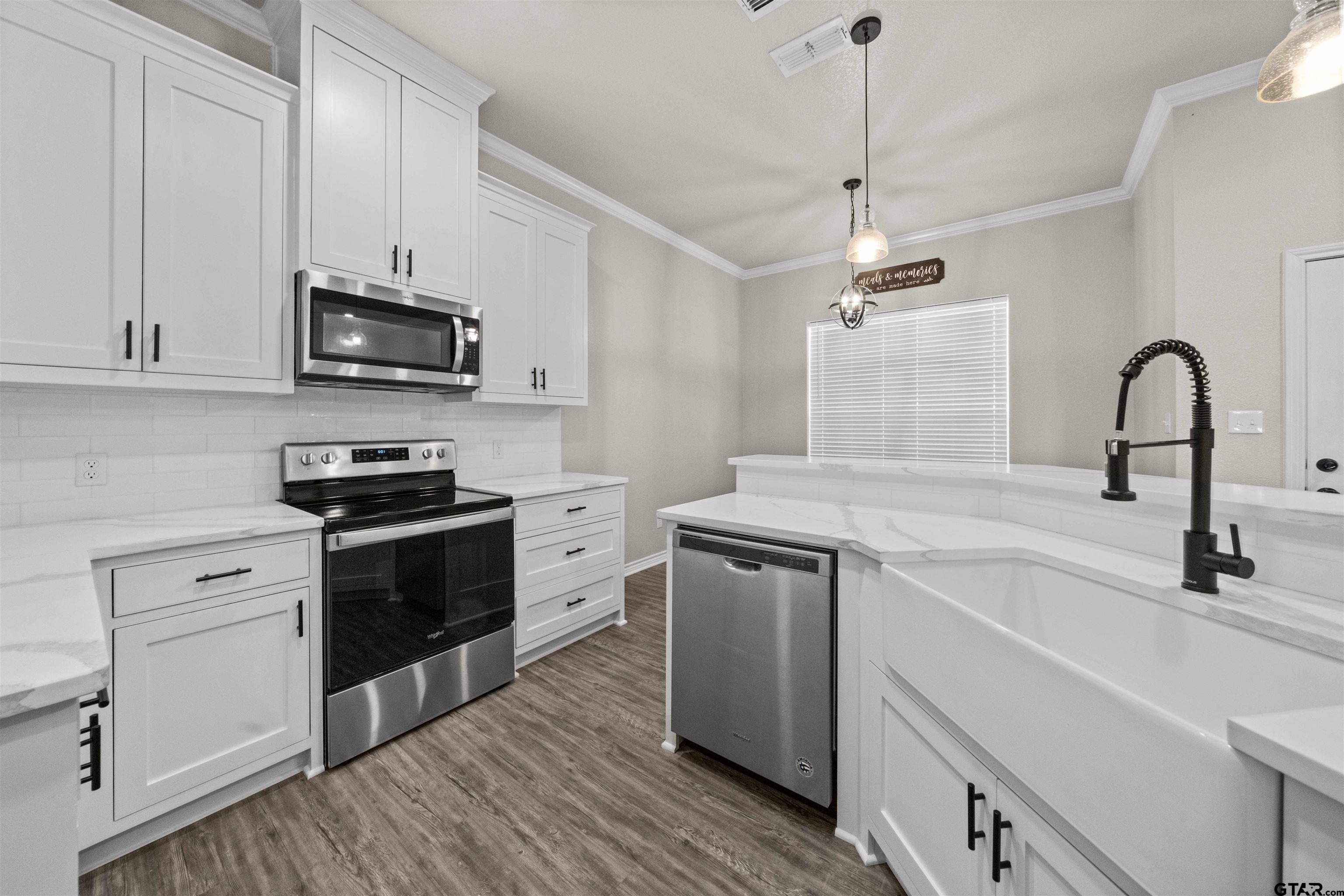 17023 County Road 2282 Troup, TX 75789 - Photo 9 of 30 a kitchen with stainless steel appliances granite countertop a sink and a stove top oven