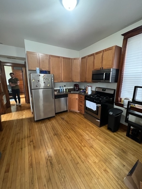 2130 West Iowa Street, Unit 1R Chicago, IL 60622 - Photo 11 of 16 a kitchen with wooden floors and wooden cabinets