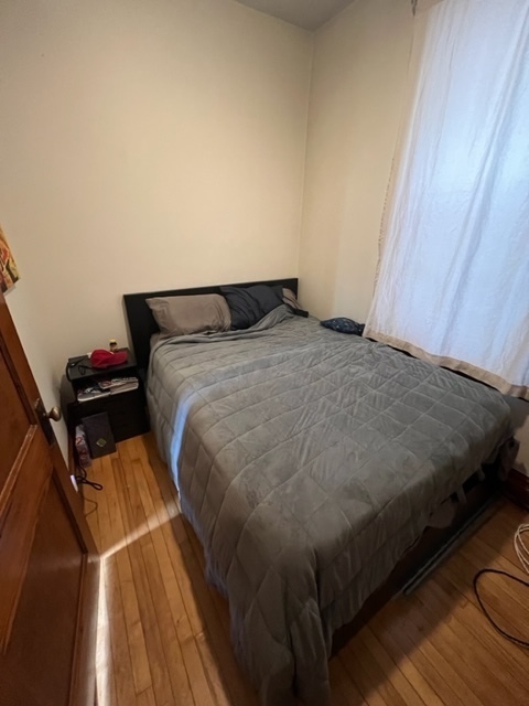 2130 West Iowa Street, Unit 1R Chicago, IL 60622 - Photo 2 of 16 a bed sitting in a bedroom next to a window
