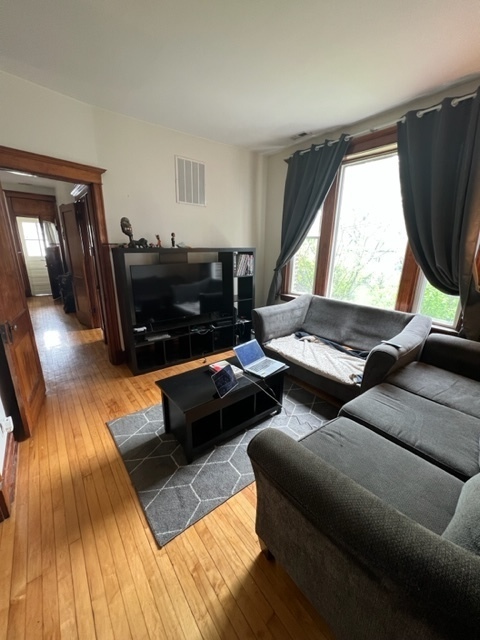 2130 West Iowa Street, Unit 1R Chicago, IL 60622 - Photo 5 of 16 a living room with furniture and a flat screen tv