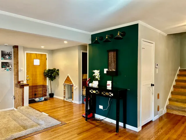 a living room with closet and a wooden floor