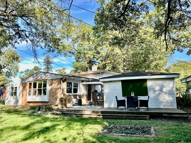 a front view of a house with a yard table and chairs