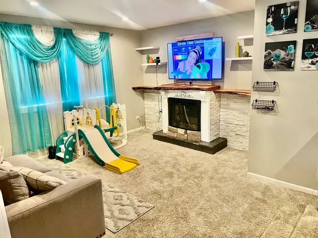 a living room with furniture a rug and a fireplace