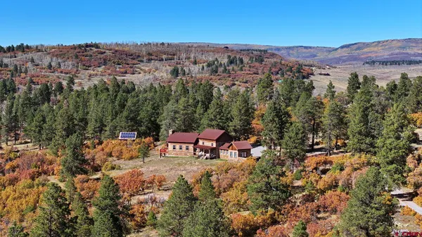 an aerial view of a house with mountain view