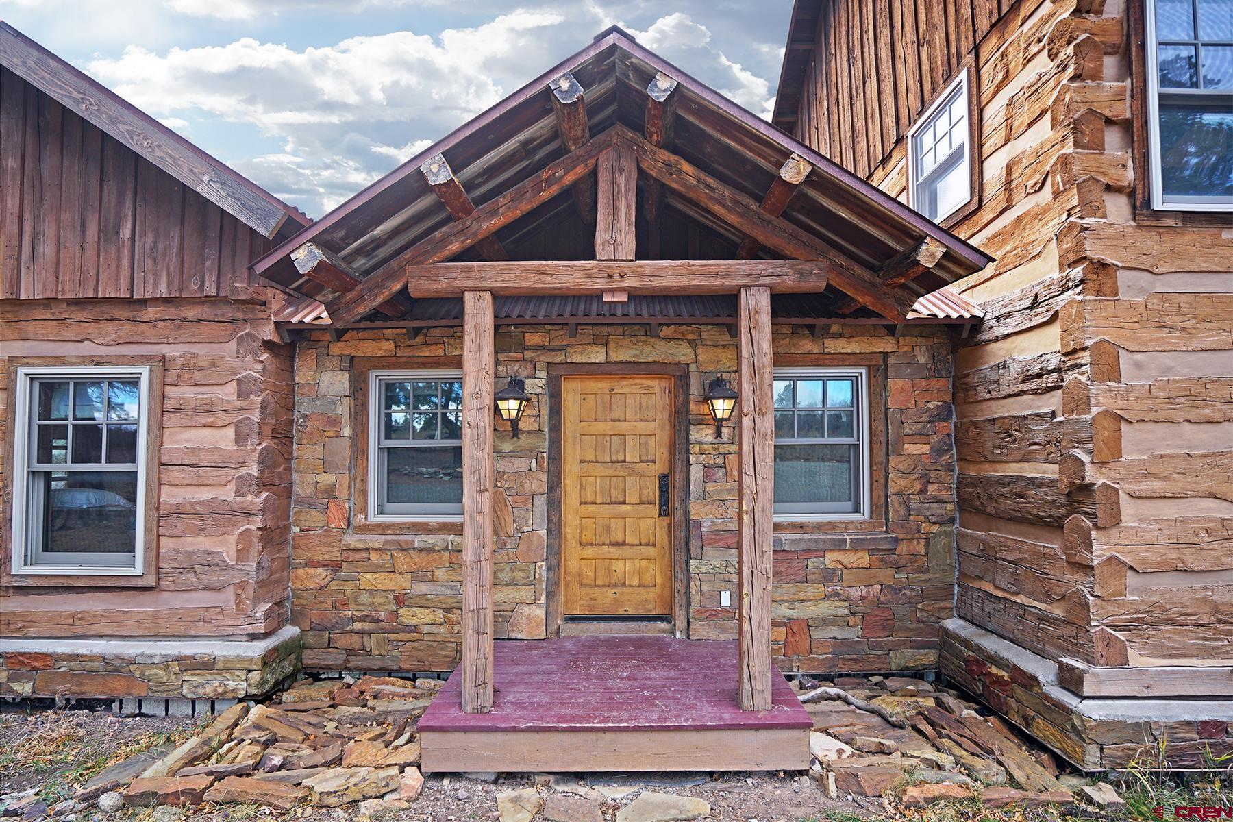 1250 McKenzie Springs Road Placerville, CO 81430 - Photo 27 of 45 a front view of a house with a yard