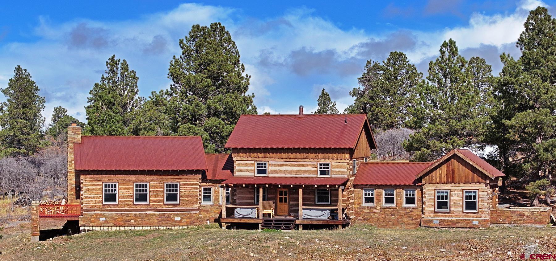 1250 McKenzie Springs Road Placerville, CO 81430 - Photo 28 of 45 a front view of a residential apartment building with a yard