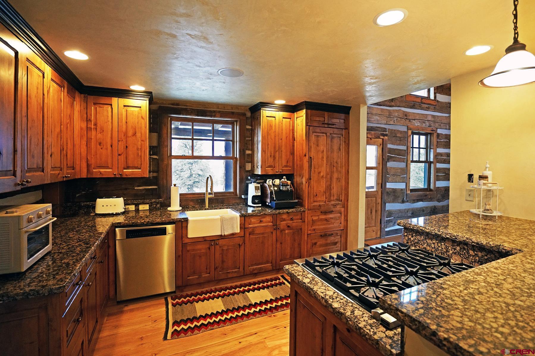 1250 McKenzie Springs Road Placerville, CO 81430 - Photo 33 of 45 a kitchen with granite countertop stainless steel appliances and wooden cabinets