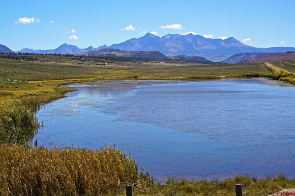 a view of a fountain in middle of the green field
