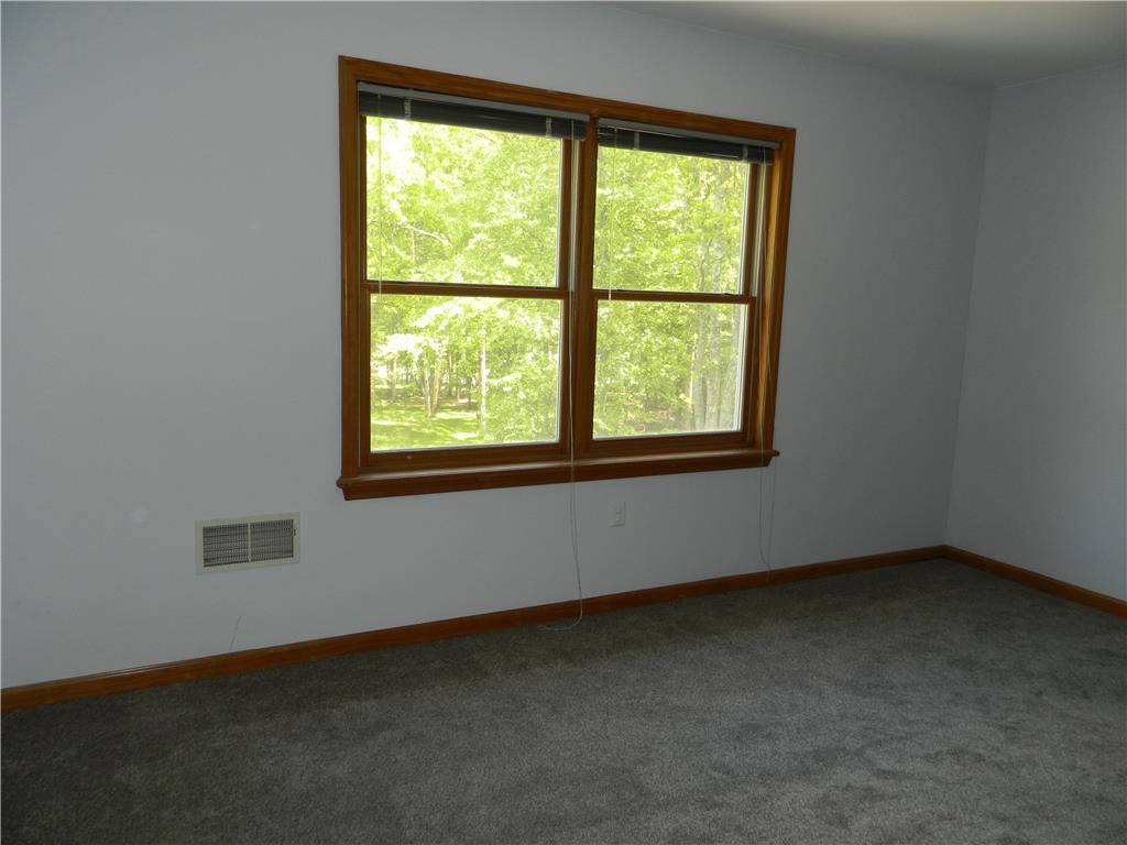 328 Pin Oak Road Stroudsburg, PA 18360 - Photo 31 of 37 A well-lit bedroom with fresh gray carpeting offers peaceful green views from its large window.
