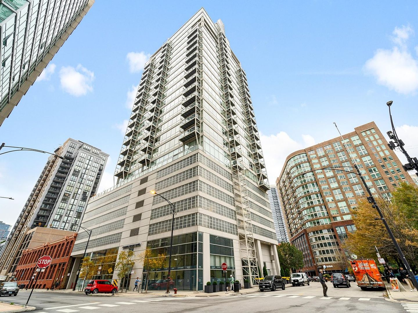a view of a tall building next to a road