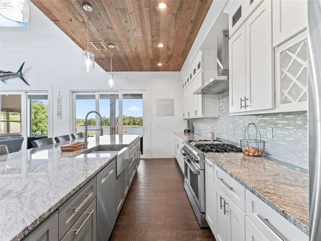 a large kitchen with stainless steel appliances granite countertop a lot of counter space